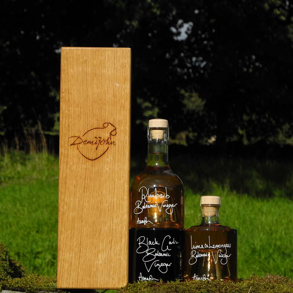 The Balsamic Dressing Set with Rhubarb Balsamic Vinegar Black Garlic Balsamic Vinegar and Lime and Lemongrass Balsamic Vinegar in stacking bottles in a handcrafted Oak presentation gift box.