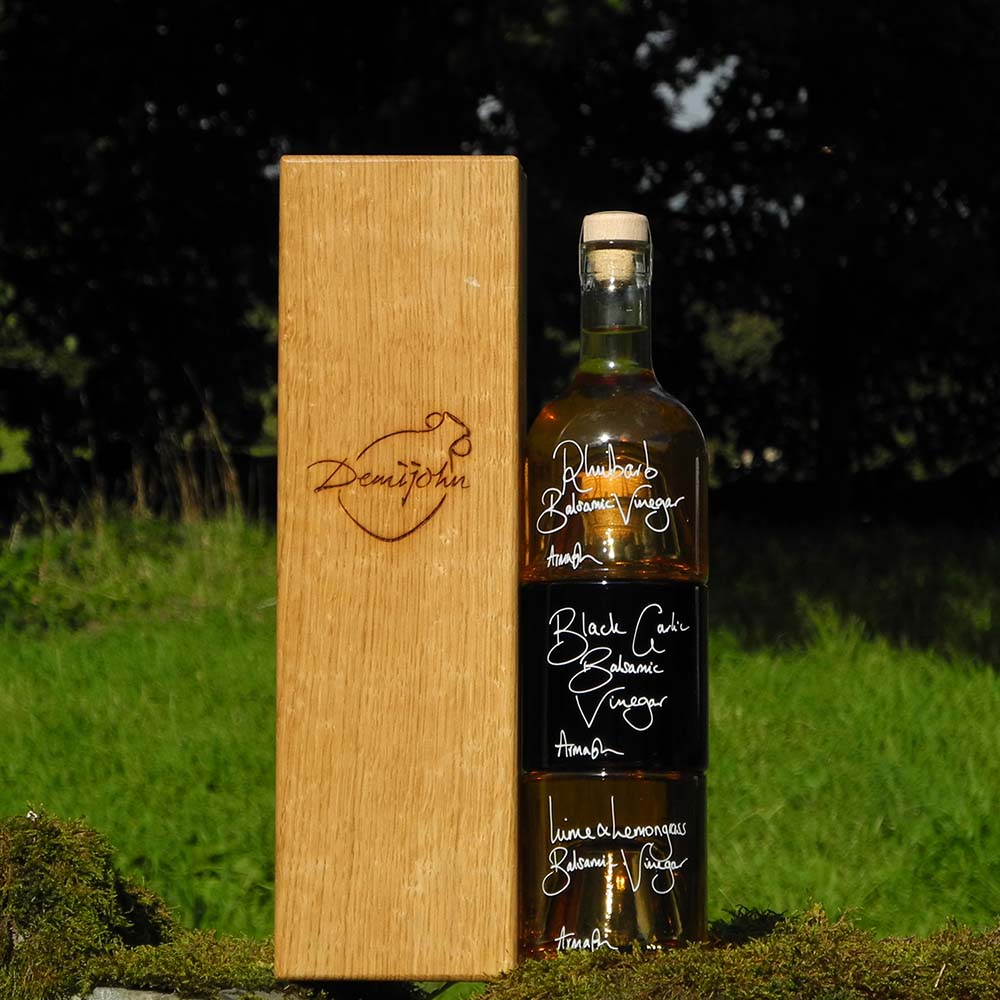The Balsamic Dressing Set with Rhubarb Balsamic Vinegar Black Garlic Balsamic Vinegar and Lime and Lemongrass Balsamic Vinegar in stacking bottles in a handcrafted Oak presentation gift box.