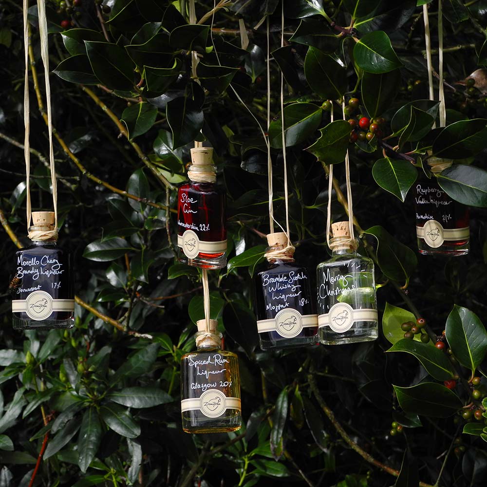 More than Gin Baubles (Set of 6 Liqueur Miniatures) includes Morello Cherry Brandy Liqueur Seville Orange Gin Bramble Scotch Whisky Liqueur Spiced Rum Liqueur Raspberry Vodka Liqueur and Sloe Gin with option for personalised Christmas message