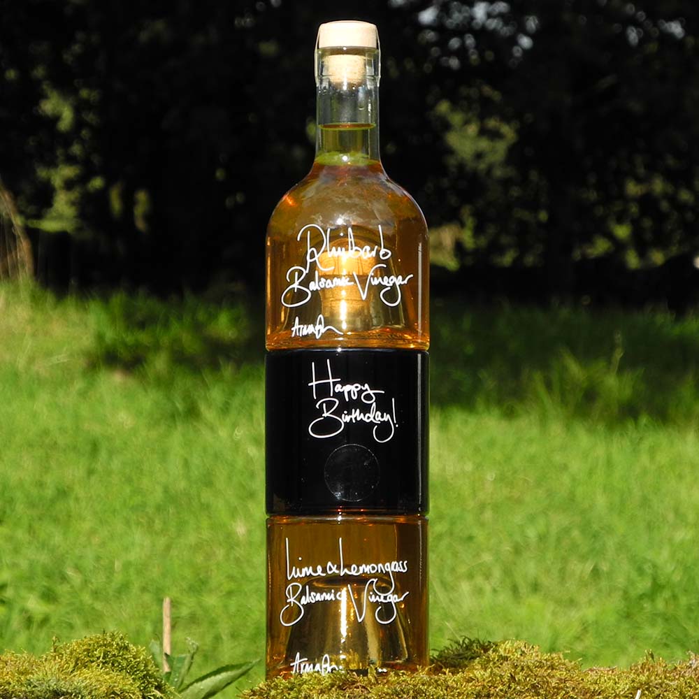 The Balsamic Dressing Gift Set with Rhubarb Balsamic Vinegar, Black Garlic Balsamic Vinegar and Lime and Lemongrass Balsamic Vinegar in stacking bottles with a handwritten personal message