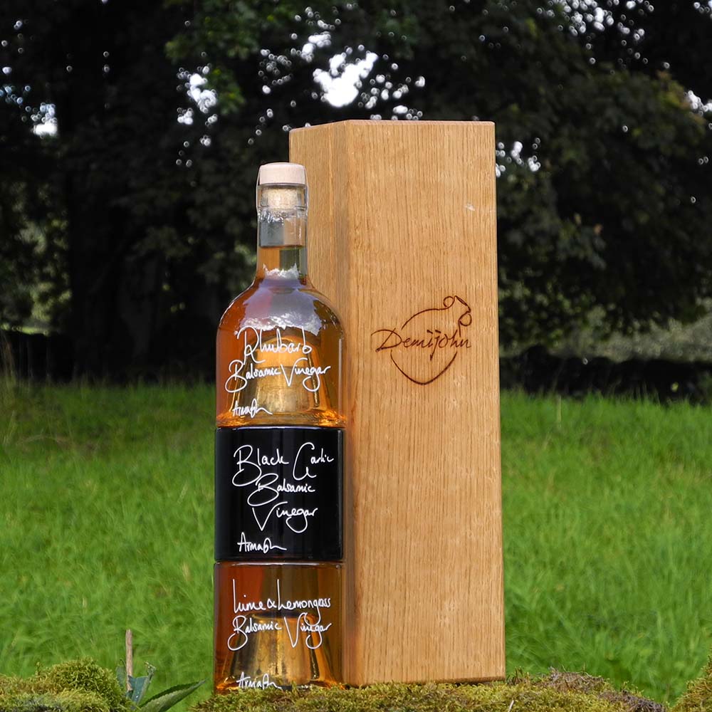 The Balsamic Dressing Set with Rhubarb Balsamic Vinegar Black Garlic Balsamic Vinegar and Lime and Lemongrass Balsamic Vinegar in stacking bottles in a handcrafted Oak presentation gift box.