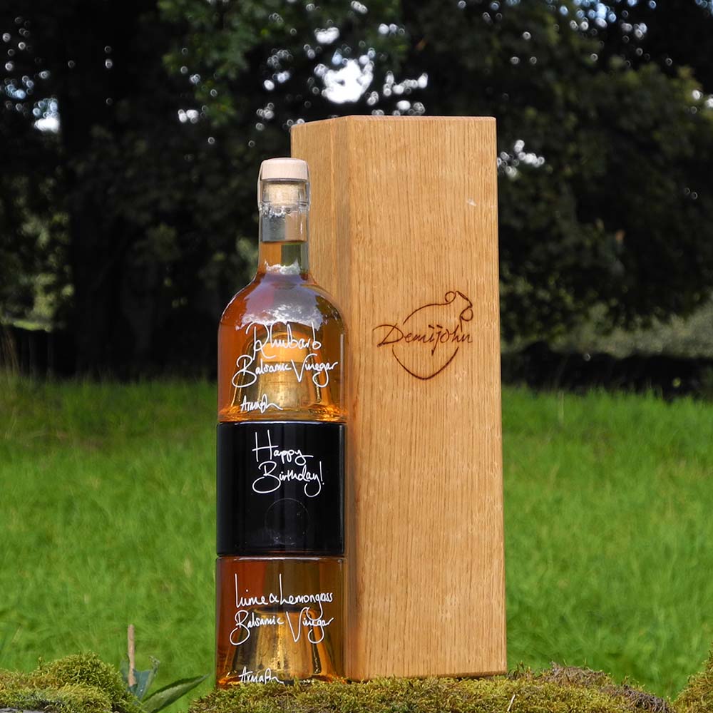 The Balsamic Dressing Set with Rhubarb Balsamic Vinegar Black Garlic Balsamic Vinegar and Lime and Lemongrass Balsamic Vinegar in stacking bottles in a handcrafted Oak presentation gift box.