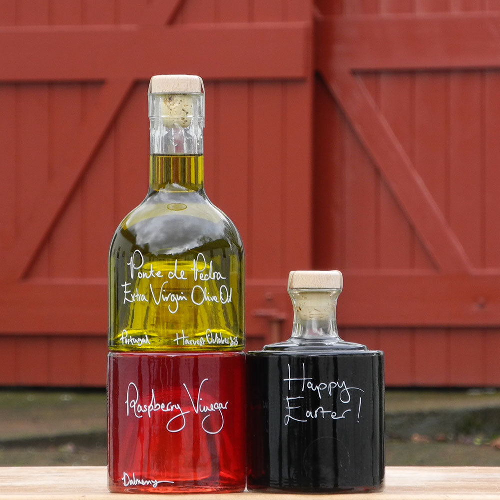 Bread Dipper and Salad Dressing Gift Set containing Portuguese Olive Oil, Black Garlic Balsamic Vinegar and Raspberry Vinegar in Stacking Bottles and handwritten bottle message that says Happy Easter