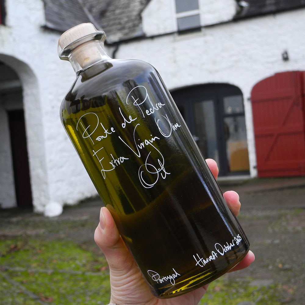 700ml bottle of Ponte de Pedra Extra Virgin Olive Oil from Portugal being held with handwritten bottle message