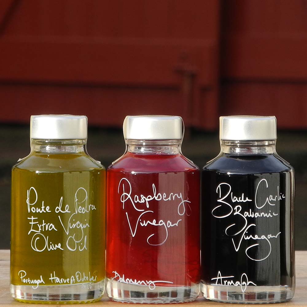 Mini Spring Bread Dipper Set with Portuguese Extra Virgin Olive Oil, Black Garlic Balsamic Vinegar and Raspberry Vinegar in 100ml bottles with handwritten labels in white pen.