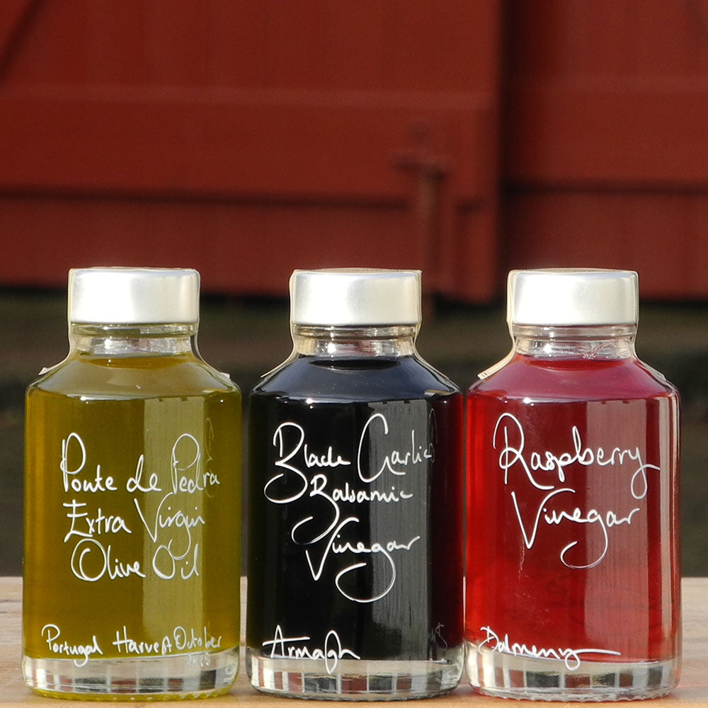 Mini Spring Bread Dipper Set with Portuguese Extra Virgin Olive Oil, Black Garlic Balsamic Vinegar and Raspberry Vinegar in 100ml bottles with handwritten labels in white pen.
